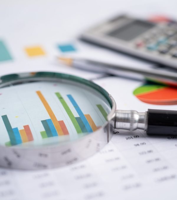 Magnifying glass on charts graphs paper. Financial development, Banking Account, Statistics, Investment Analytic research data economy, Stock exchange trading, Business office company meeting concept.